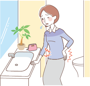 トイレの洗面台の前でつらそうにしている女性